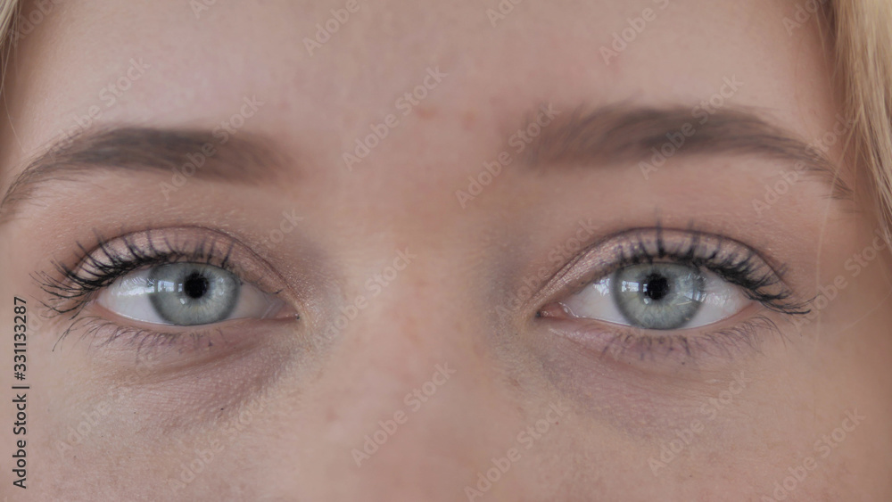 Fototapeta premium Blinking Eyes Of Young Blonde Woman