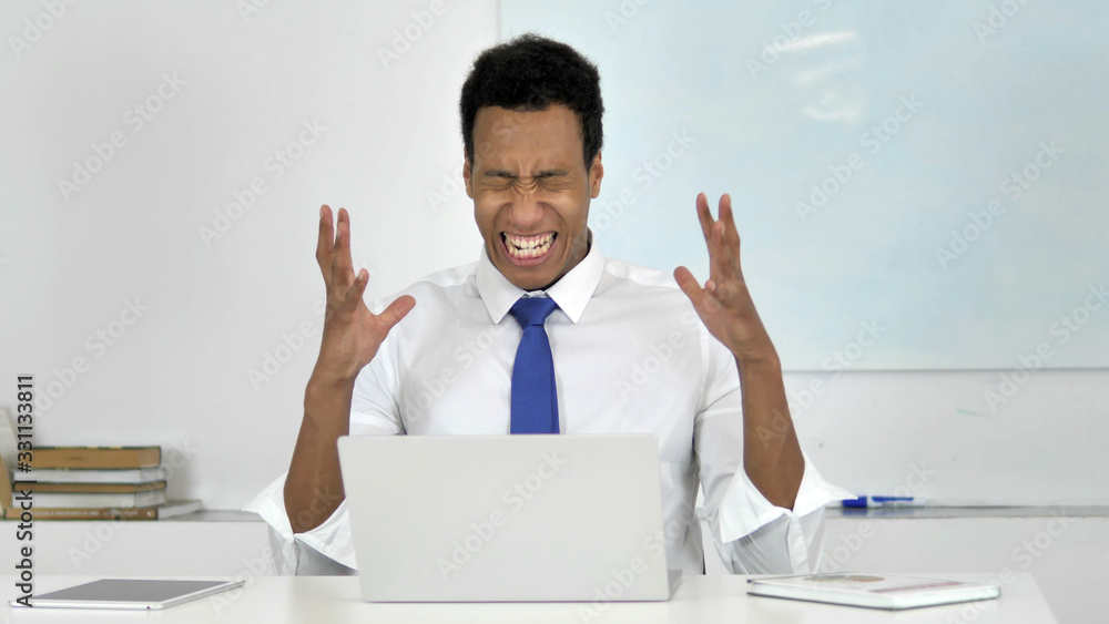 Afro-American Businessman in Anger and Frustration Going Crazy at Work Afro-American Businessman in Anger and Frustration Going Crazy at Work