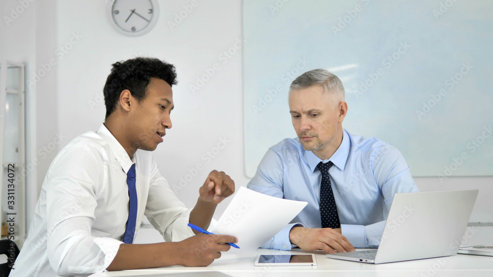 Obraz premium African Businessman Discussing Project Documents with Senior Grey Hair Businessman