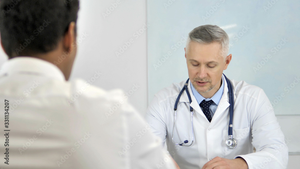 Senior Doctor Advising Patient, Helping with Health Issues Senior Doctor Advising Patient, Helping with Health Issues