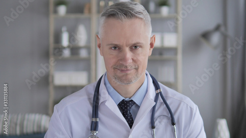Yes, Doctor with Grey Hairs Shaking Head to Agree