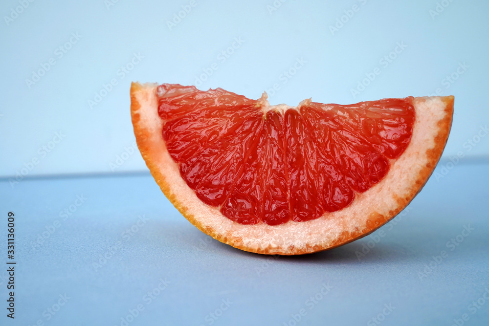 slice of grapefruit on blue background