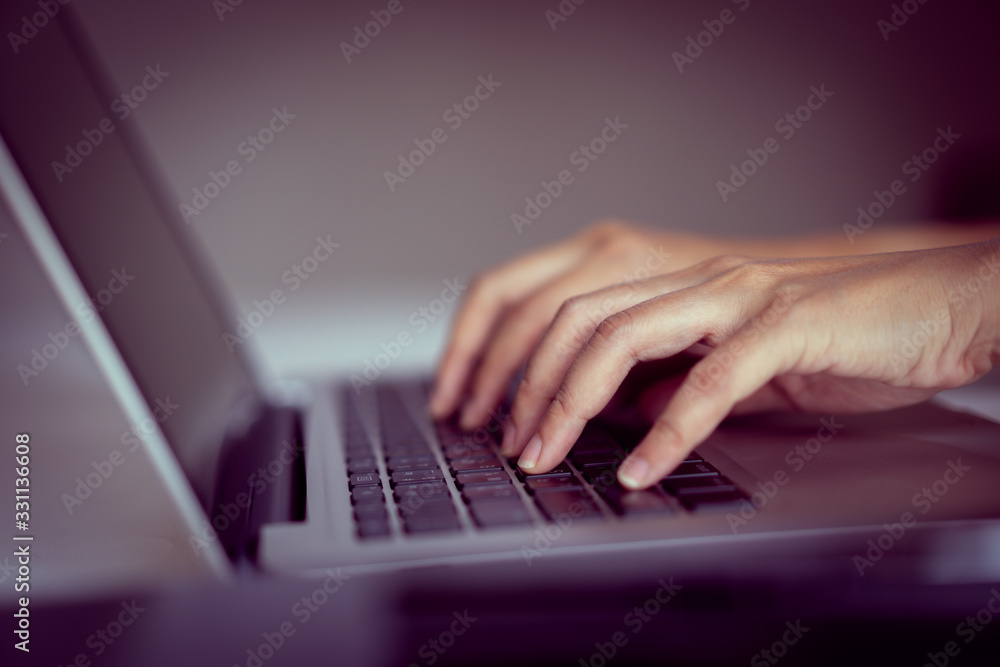 hand on laptop keyboard with clean background, work at home concept hand on laptop keyboard with clean background, work at home concept