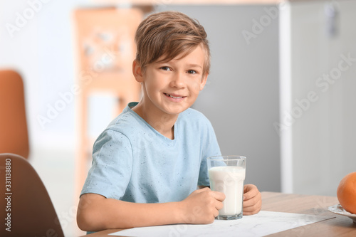 Little boy with milk in kit...