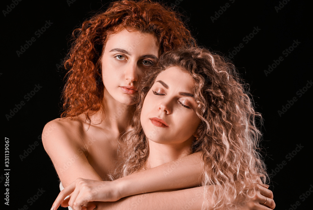 Obraz premium Beautiful young women on dark background