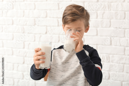 Little boy with milk on whi...