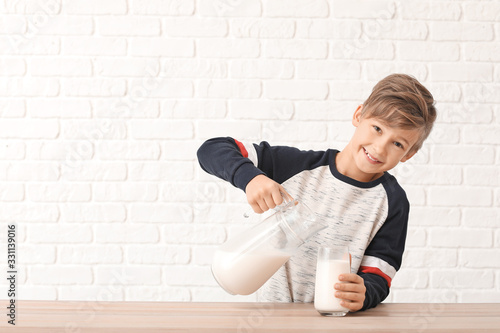 Little boy with milk on whi...