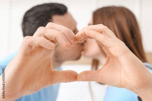 Young couple making heart s...