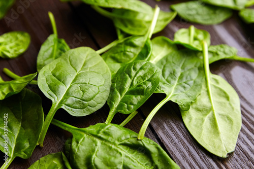 Spinach fresh green leaves in a wooden background
