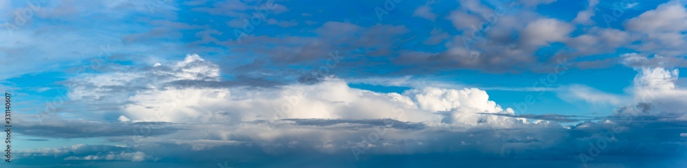 Fantastic clouds against blue sky, panorama