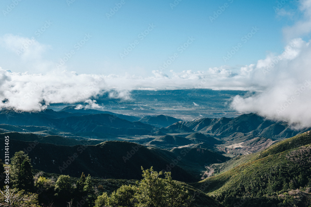 Breathtaking mountain view scenery with foggy clouds and blue sky