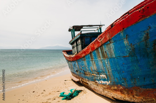 Old fishing boat, rust on the hull. A traditional Asian fishing boat. Travel in Vietnam