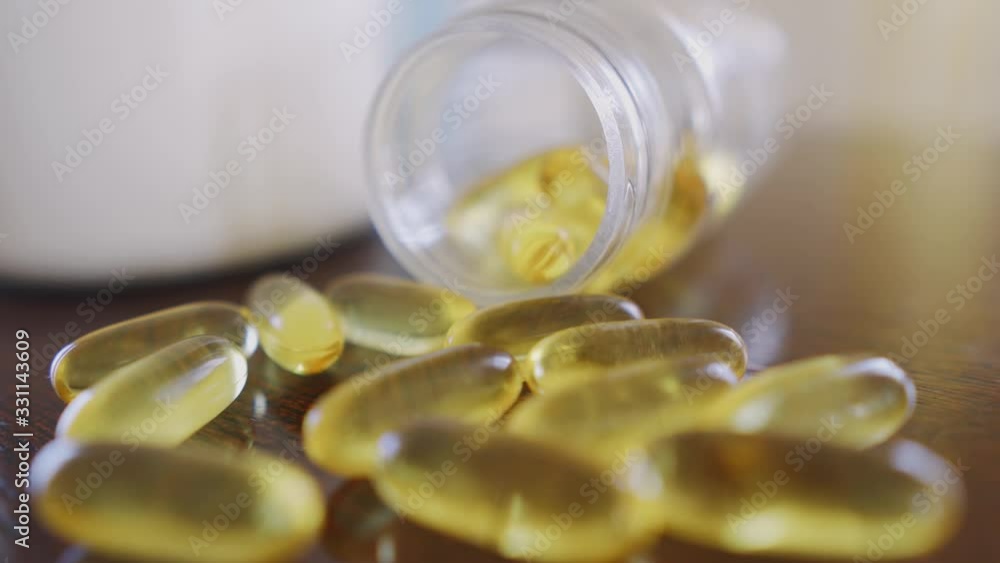 Capsules omega 3 close up on the table dolly shot using shallow depth of field Capsules omega 3 close up on the table dolly shot using shallow depth of field