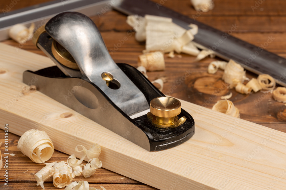 Chisel and small block plane with wood shavings - obrazy, fototapety, plakaty 