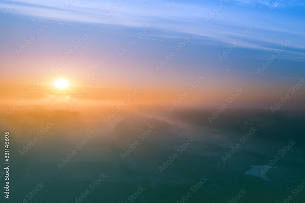 Early misty morning. Sunrise in countryside. Rural landscape in early spring. Aerial view Early misty morning. Sunrise in countryside. Rural landscape in early spring. Aerial view