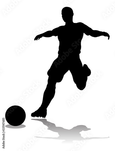 A soccer or football player in silhouette