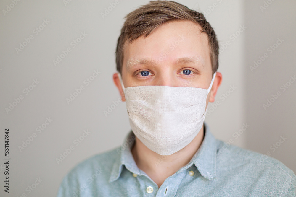 handsome European man wearing a coronavirus mask portrait. Protection from the coronavirus pandemic. Quarantine. white background lifestyle. Doctor pneumonia medicine Allergy virus protection handsome European man wearing a coronavirus mask portrait. Protection from the coronavirus pandemic. Quarantine. white background lifestyle. Doctor pneumonia medicine Allergy virus protection