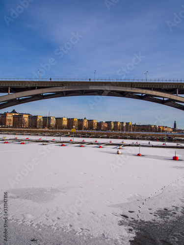 Photography västerbron bridge and boat moorings in stockholm in winter