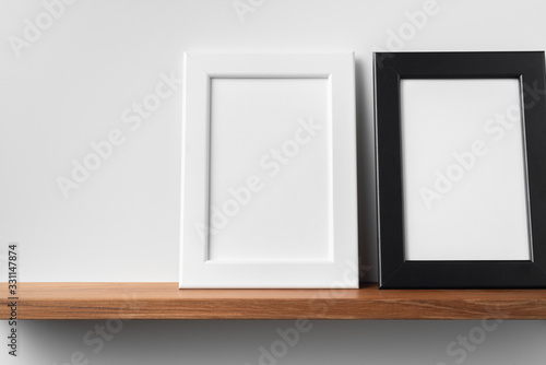 vertical wood photo on bookshelf and wall