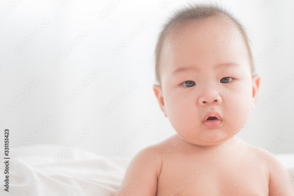 newborn child relaxing in bed. adorable baby boy in white sunny bedroom. nursery for young children. textile and bedding for kids. family morning at home. six month. childhood and baby care concept. newborn child relaxing in bed. adorable baby boy in white sunny bedroom. nursery for young children. textile and bedding for kids. family morning at home. six month. childhood and baby care concept.