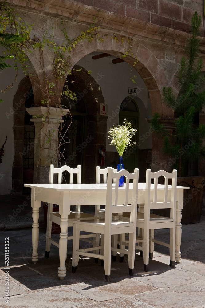 Cusco Peru. Interior. Chairs table. Flowers