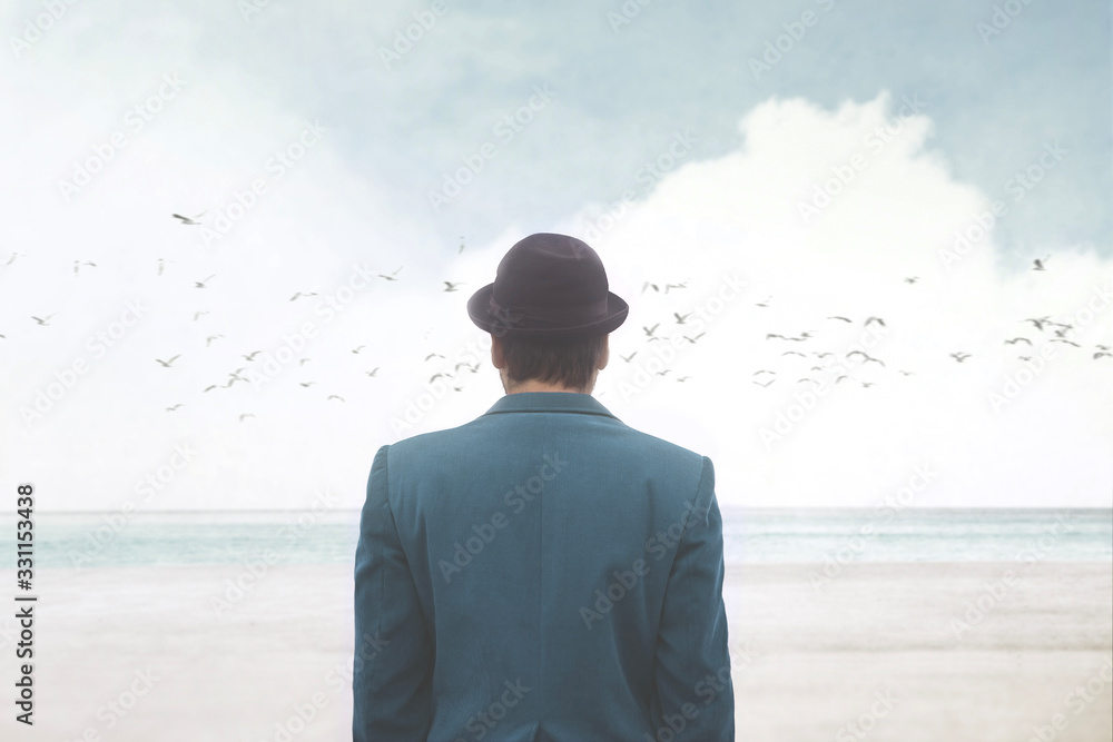 man in blue suite and bowler observing seagulls over the sea, surreal abstract concept - obrazy, fototapety, plakaty 