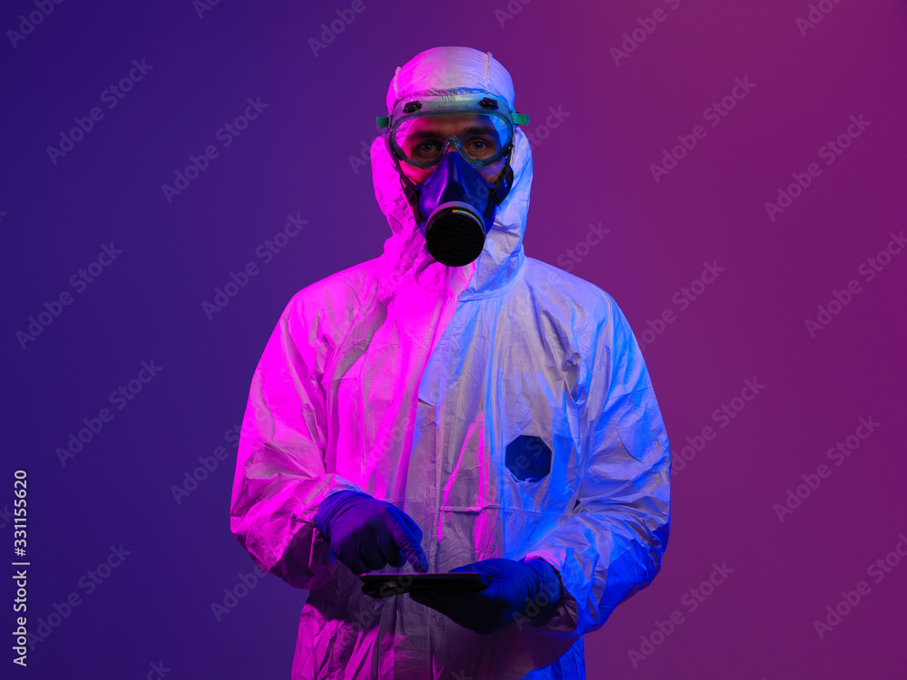 Doctor wearing protective biological suit and mask due to coronavirus Doctor wearing protective biological suit and mask due to coronavirus