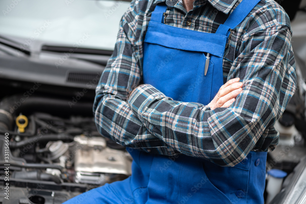 Portrait of car mechanic with arm crossed
