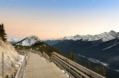 Spectacular sunset Canadian rocky mountains and boardwalk on Sulphur Mountain connect to Gondola landing in Banff, Canada. Gondola ride to Sulphur Moutain overlooks the Bow Valley and Baff town  photo