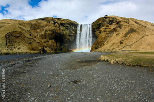 Beautiful high waterfall with a rainbow in Iceland