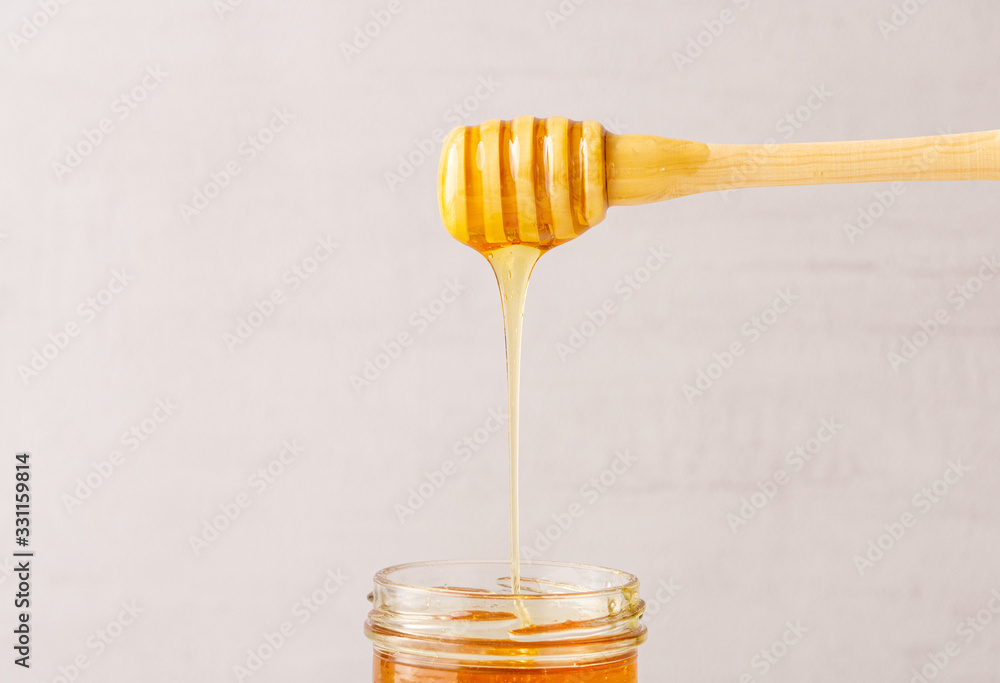 Honey jar, pot, wooden spoon. Health. immunity. Isolated. Copy space. Honey jar, pot, wooden spoon. Health. immunity. Isolated. Copy space.