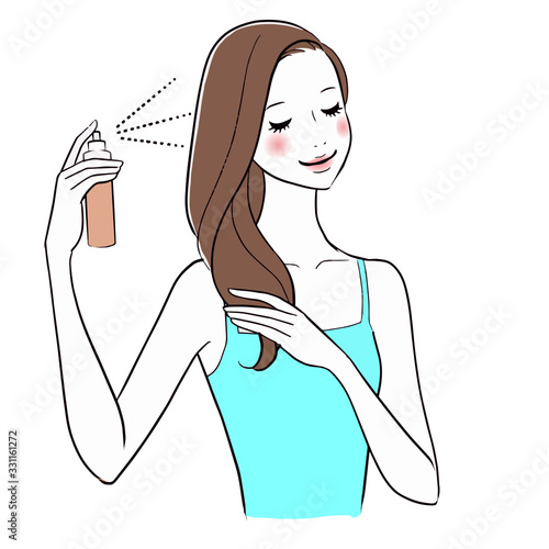Beautiful woman applying hair spray on her hair.