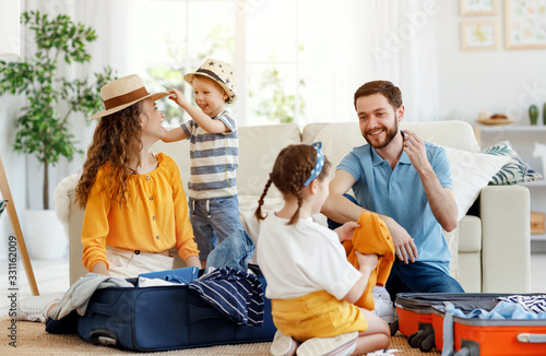 Playful family packing for holiday at home