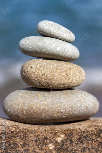 Stones balance, pebbles stack over blue sea in Croatia. Blue sky on sunny adriatic coast in summer