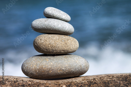 Stones balance  pebbles stack over blue sea in Croatia. Blue sky on sunny adriatic coast in summer