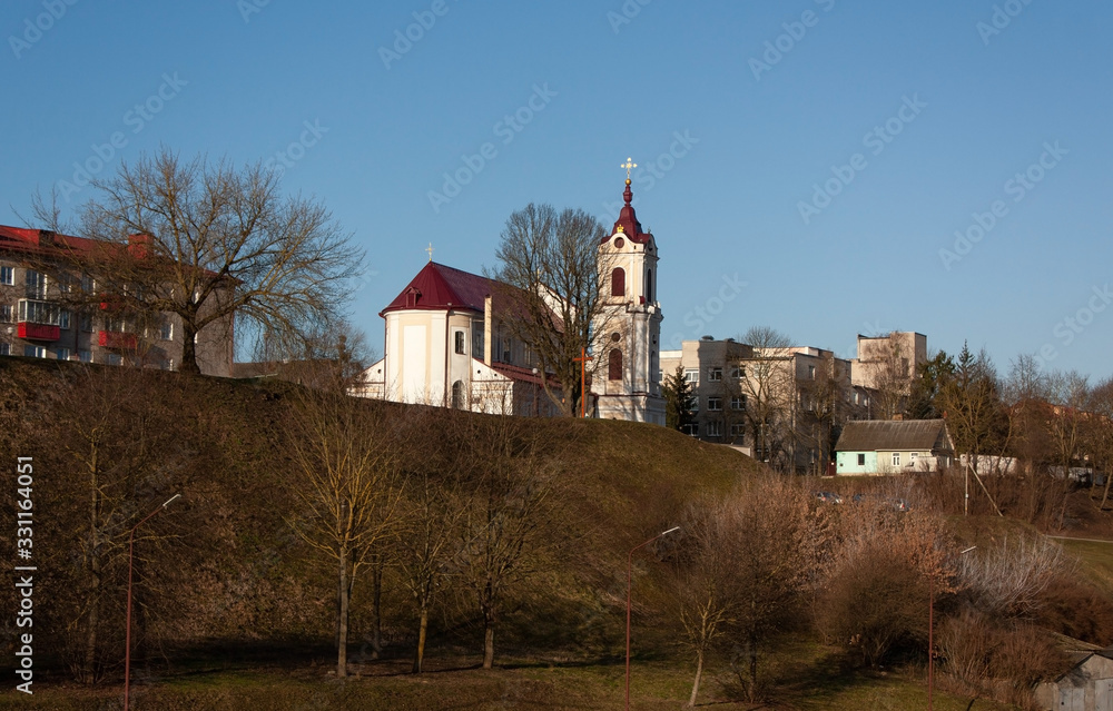 Grodno. Belarus. Against the spring blue sky, a church on a high hill and other city buildings. Grodno. Belarus. Against the spring blue sky, a church on a high hill and other city buildings.