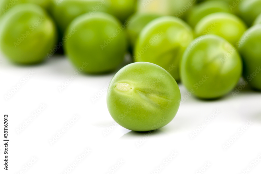 fresh green peas on a white background. Shallow depth of field fresh green peas on a white background. Shallow depth of field