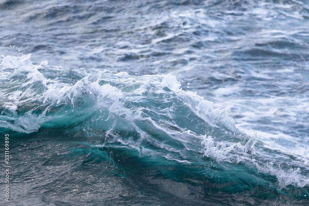 White crest of a sea wave. Selective focus. Shallow depth of field