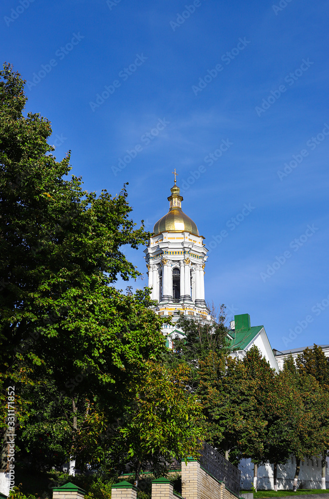 View of the temples of Kiev-Pechersk Lavra on a beautiful sunny autumn day. Gold domes, orthodox crosses. UNESCO World Heritage Site