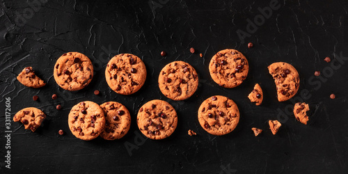 Chocolate chip cookies panorama on a black background, shot from above, a flat lay