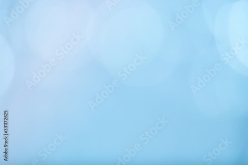 Abstract bokeh sparkle on light blue background