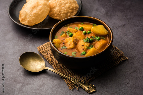 Aloo Puri or Potato curry with fried Poori, popular Indian breakfast / lunch / dinner menu. photo