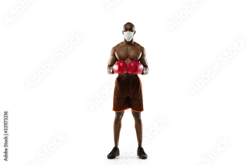 Beat the disease. Male african-american boxer in protective mask. Prevention against pneumonia. Still active while quarantine. Chinese coronavirus treatment. Healthcare, medicine, sport concept. © master1305