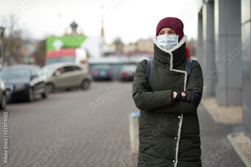 Caucasian woman wearing medical mask outdoors during outbreak