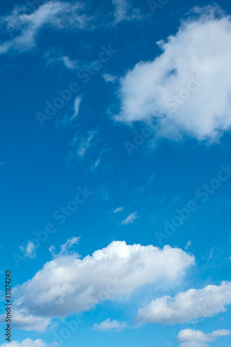 a group of white cirrus clouds in the blue sky as a natural background