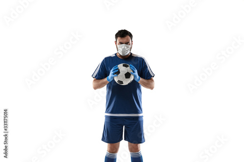 Punching virus. Football, soccer player in protective mask and gloves. Prevention against pneumonia. Still active while quarantine. Chinese coronavirus treatment. Healthcare, medicine, sport concept.