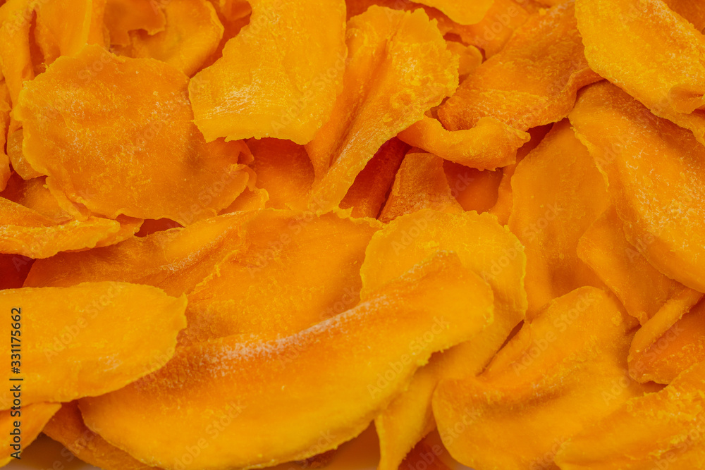 Tasty sugar mango slices background. Top view. Tasty sugar mango slices background. Top view.