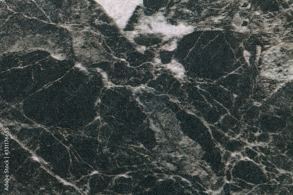 Texture of black marble with white lines of a pattern, macro background. Dark gray stone backdrop from mineral tile Texture of black marble with white lines of a pattern, macro background. Dark gray stone backdrop from mineral tile