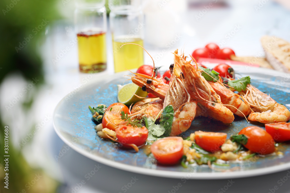 Shrimps in lemon butter sauce with cherry tomatoes. A tasty crustacean dish. A plate with an appetizing dish. Application suggestion. Culinary photography, food stylization. Shrimps in lemon butter sauce with cherry tomatoes. A tasty crustacean dish. A plate with an appetizing dish. Application suggestion. Culinary photography, food stylization.