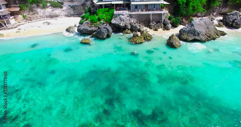 Uluwatu, Bali, Indonesia, aerial view to the small villa on the ocean beach. Summer time on Bali. Uluwatu, Bali, Indonesia, aerial view to the small villa on the ocean beach. Summer time on Bali.